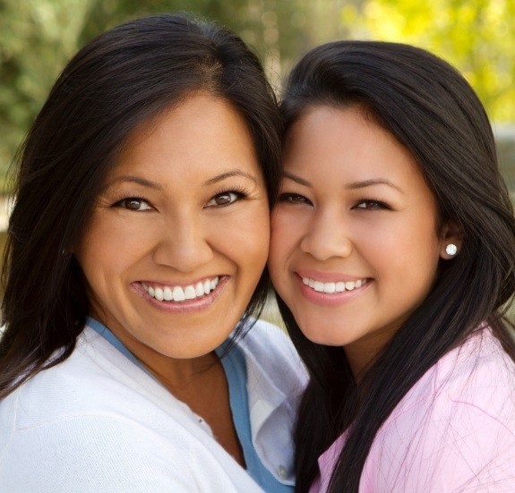 Mother and daughter smiling with straight teeth