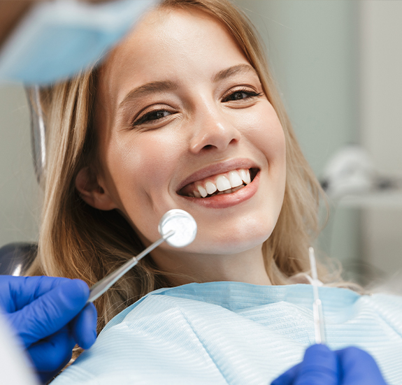 Woman smiling right before dental exam