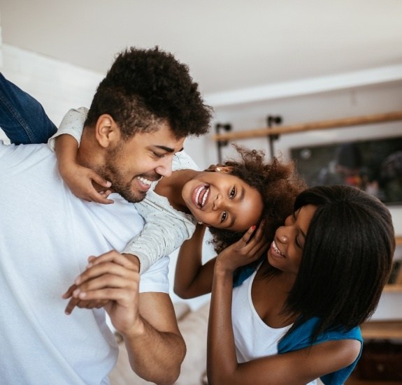 Family of three laughing together