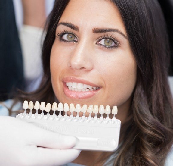 Woman trying on veneers from cosmetic dentist