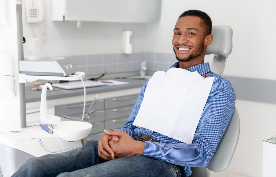 Smiling man sitting patiently in dental chair