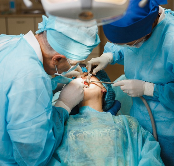 Dentists performing an full arch implant restorations procedure