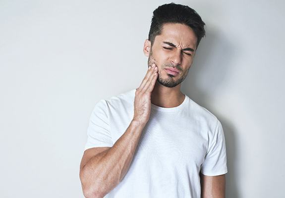 Man dealing with mouth pain