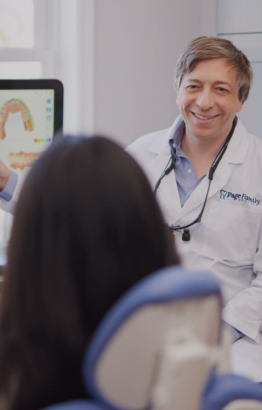 Doctor Page showing a patient digital models of teeth on computer monitor