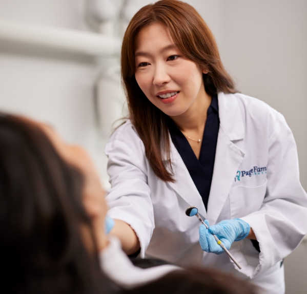 Dentist looking inside of patients mouth