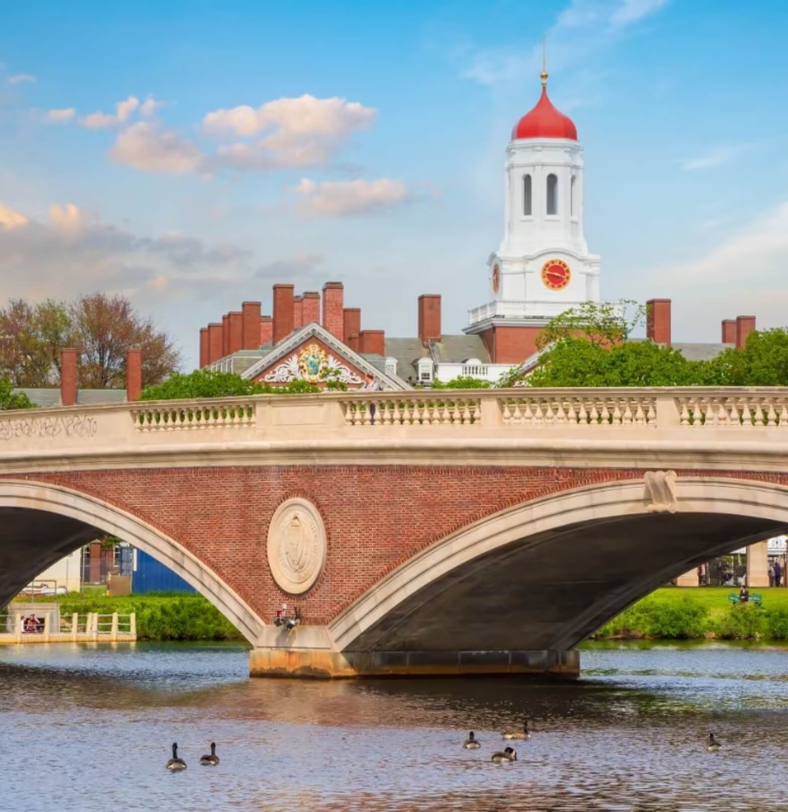 Bridge above small river with academic buildings in background